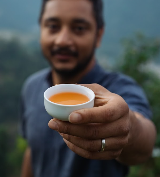A man holding a cup of tea.