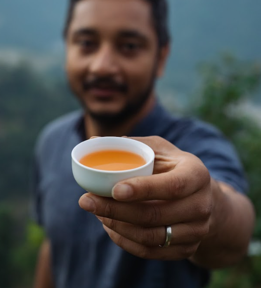 A man holding a cup of tea. 