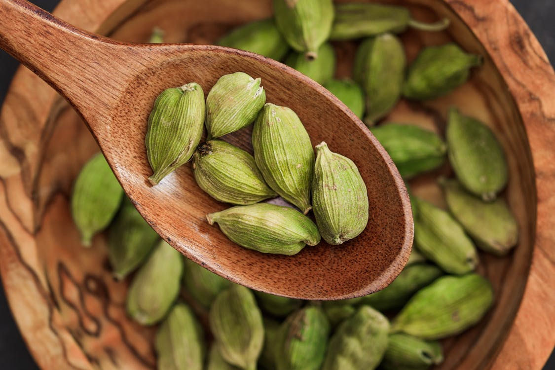 A bowl filled with cardamom.